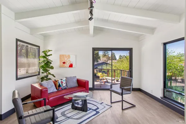 a view of a house with swimming pool and sitting area
