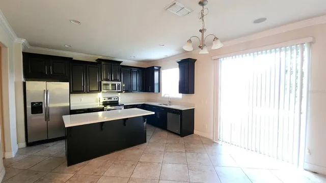 a kitchen with stainless steel appliances granite countertop a sink counter space cabinets and a window