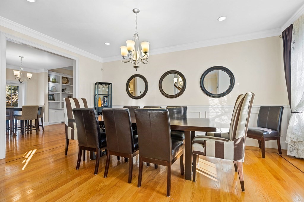 2050 Washington Street Canton, MA 02021 - Photo 12 of 35 a view of a dining room and livingroom with furniture wooden floor and a clock