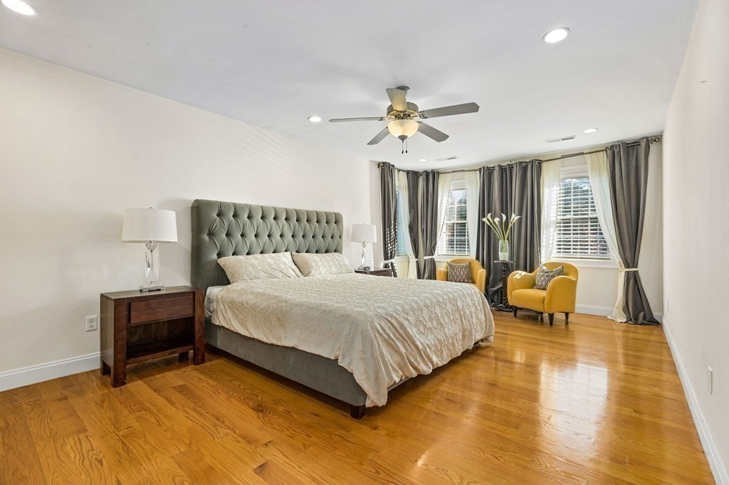 2050 Washington Street Canton, MA 02021 - Photo 18 of 35 a bedroom with a bed and ceiling fan