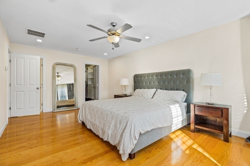 2050 Washington Street Canton, MA 02021 - Photo 19 of 35 a bedroom with a bed and a chandelier