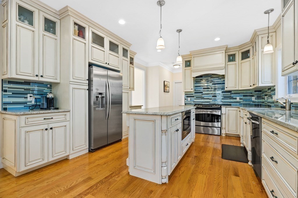 2050 Washington Street Canton, MA 02021 - Photo 2 of 35 a kitchen with stainless steel appliances granite countertop a refrigerator a stove and a wooden floors