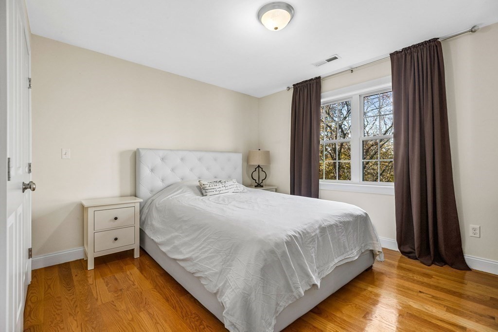 2050 Washington Street Canton, MA 02021 - Photo 23 of 35 a bedroom with a bed and large windows