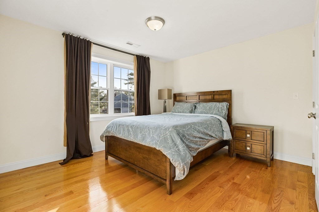 2050 Washington Street Canton, MA 02021 - Photo 24 of 35 a bed sitting in a bedroom next to a window