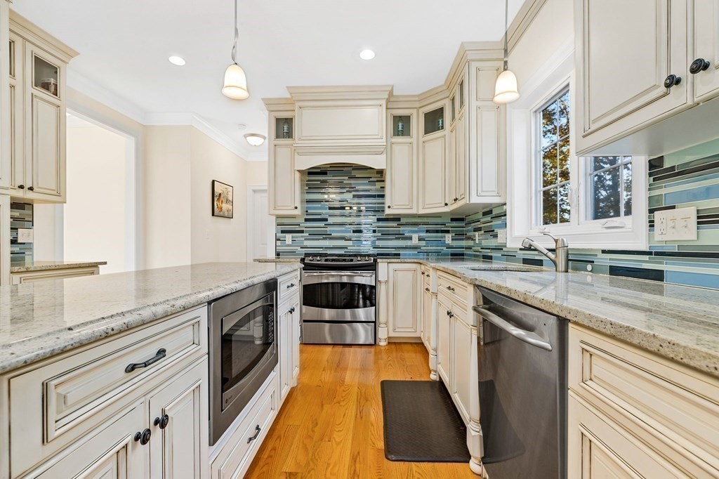 2050 Washington Street Canton, MA 02021 - Photo 3 of 35 a large kitchen with stainless steel appliances granite countertop a sink stove and cabinets