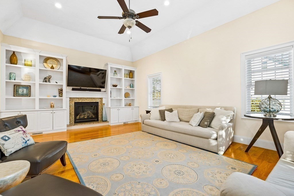 2050 Washington Street Canton, MA 02021 - Photo 6 of 35 a living room with furniture a flat screen tv and a fireplace