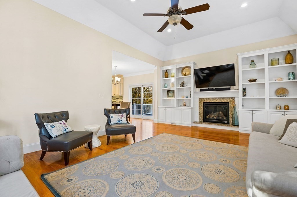 2050 Washington Street Canton, MA 02021 - Photo 9 of 35 a living room with furniture a flat screen tv and a fireplace