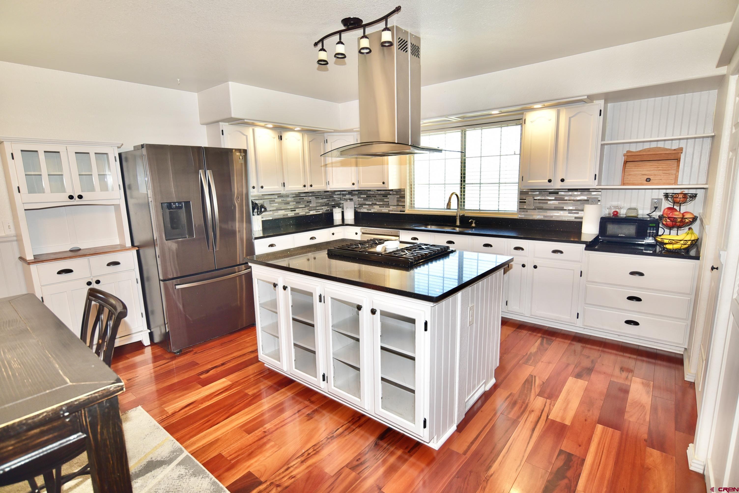 61460 Epitaph Road Montrose, CO 81403 - Photo 11 of 45 a kitchen with stainless steel appliances a stove a sink and a refrigerator