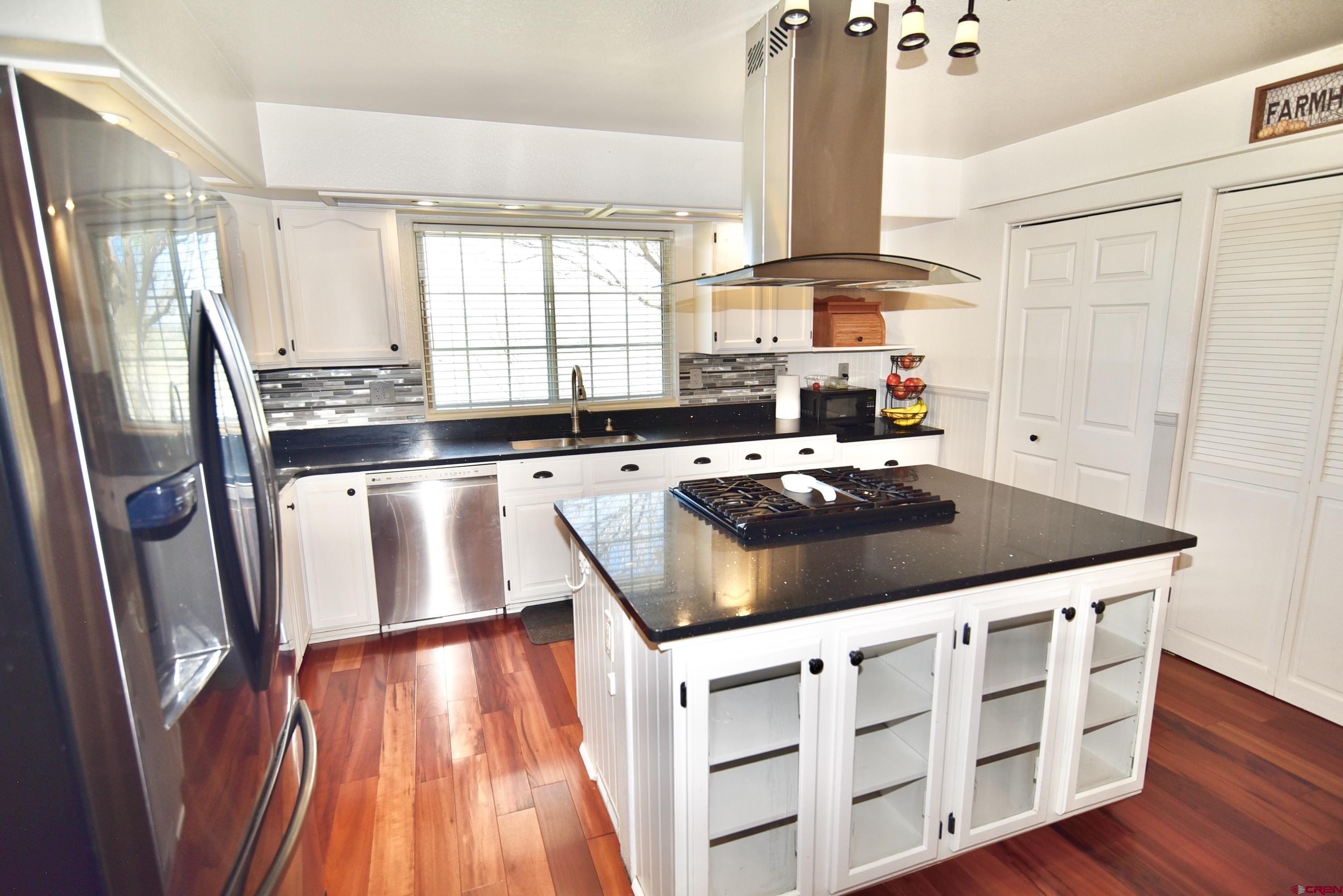 61460 Epitaph Road Montrose, CO 81403 - Photo 12 of 45 a kitchen with stainless steel appliances granite countertop a stove a sink and a refrigerator
