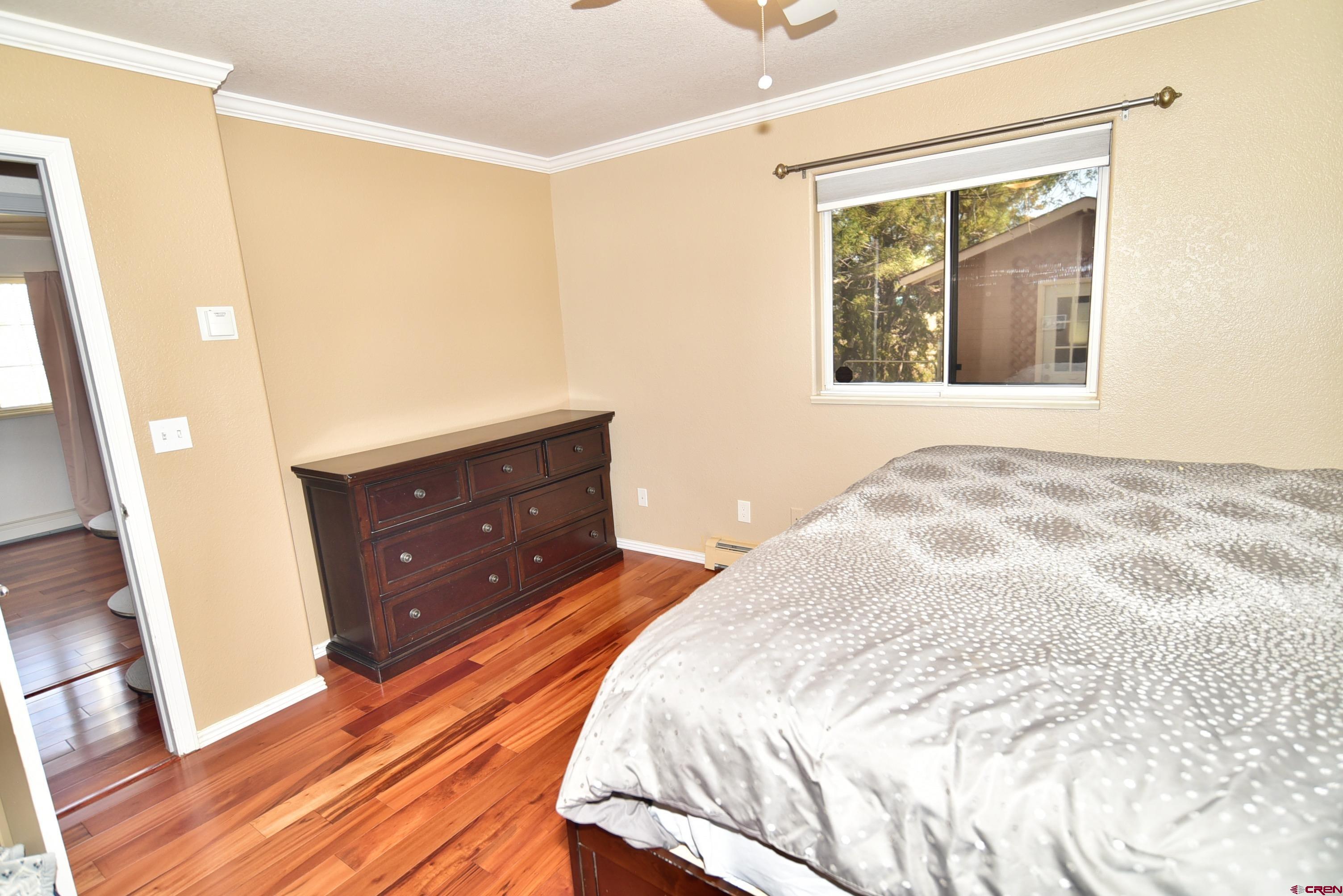 61460 Epitaph Road Montrose, CO 81403 - Photo 17 of 45 a bedroom with a bed and a dresser
