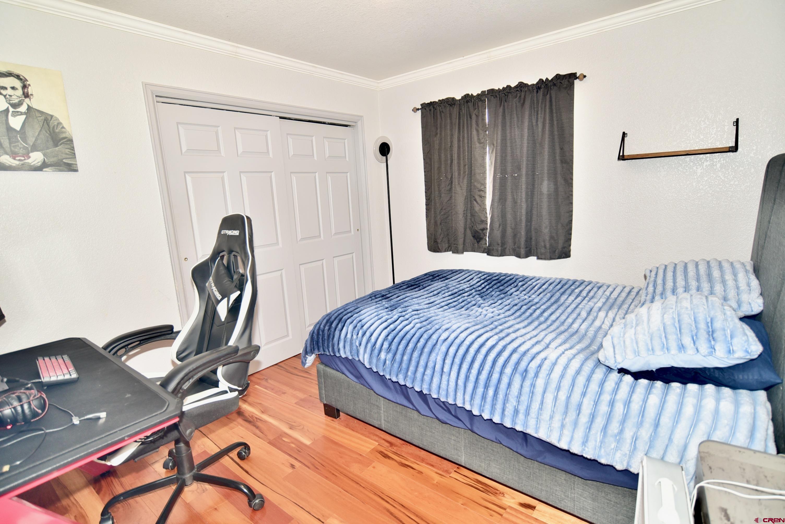 61460 Epitaph Road Montrose, CO 81403 - Photo 20 of 45 a bedroom with a bed and a desk