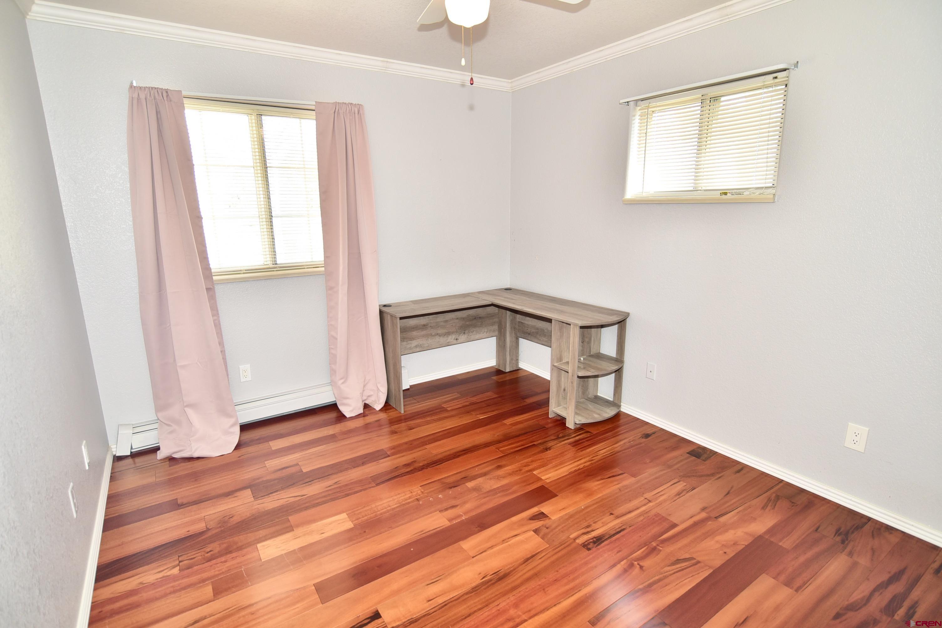 61460 Epitaph Road Montrose, CO 81403 - Photo 21 of 45 a view of empty room with wooden floor