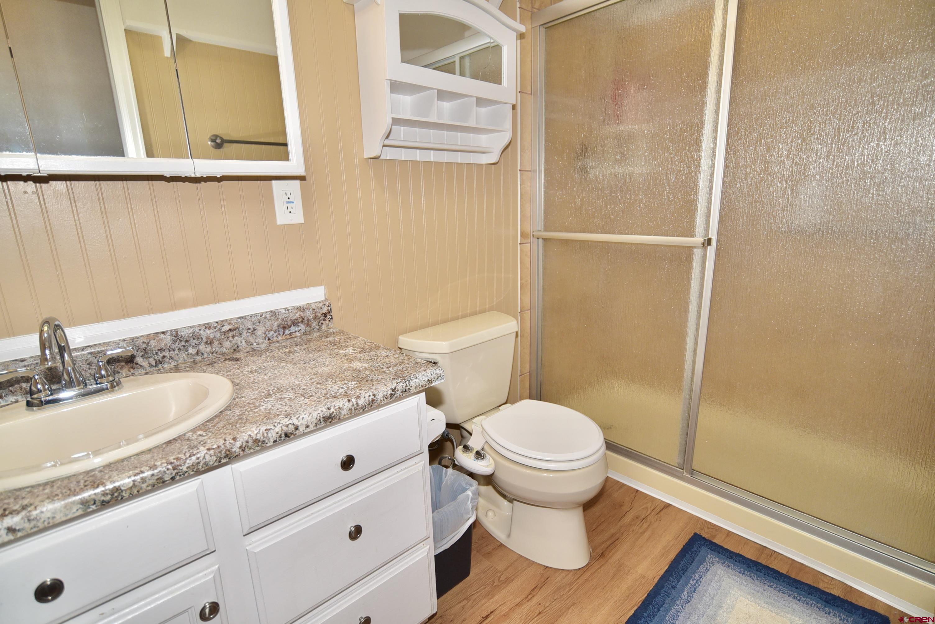 61460 Epitaph Road Montrose, CO 81403 - Photo 23 of 45 a bathroom with a granite countertop sink toilet and a mirror
