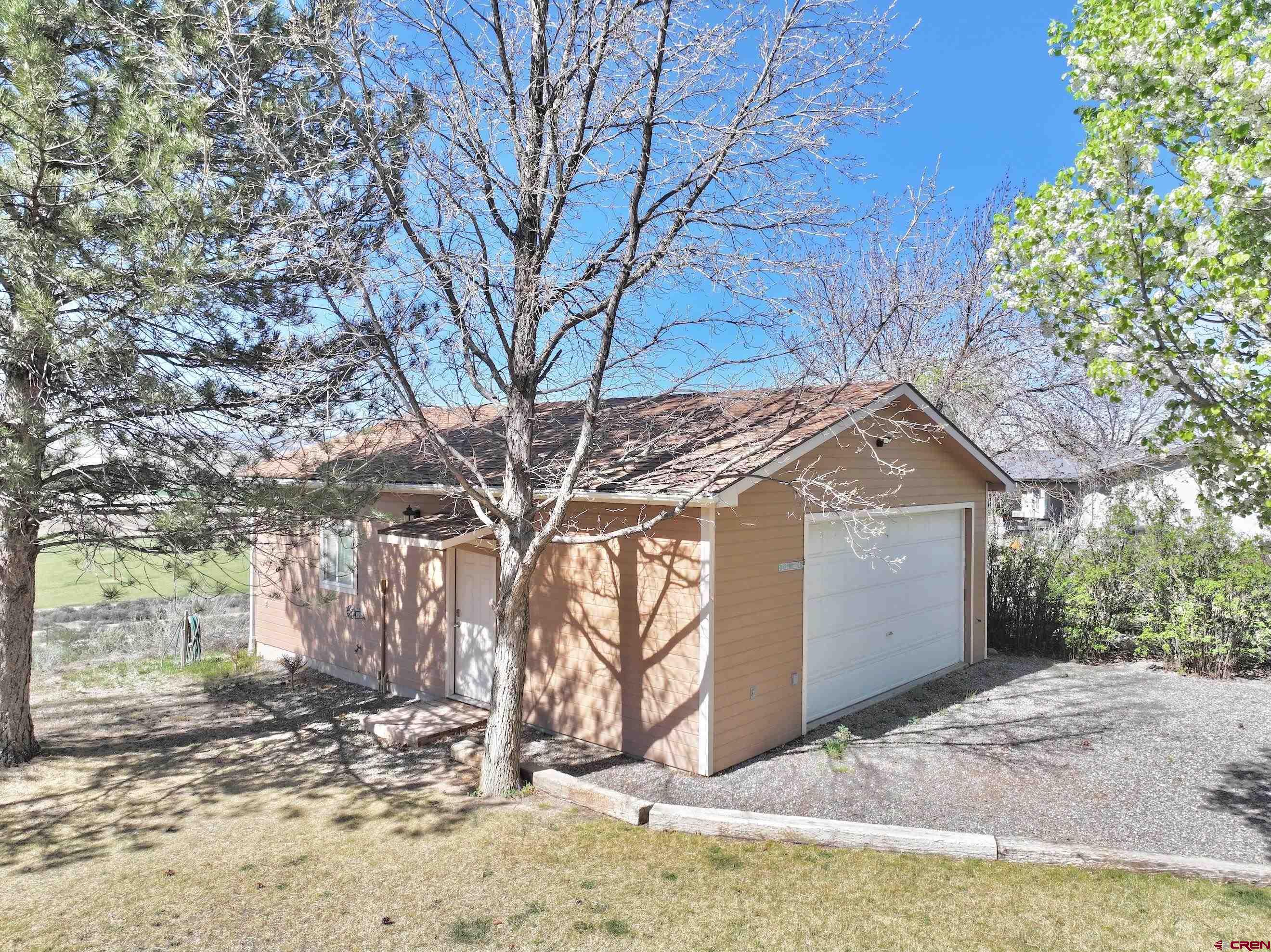 61460 Epitaph Road Montrose, CO 81403 - Photo 25 of 45 a view of a yard covered with snow in front of house