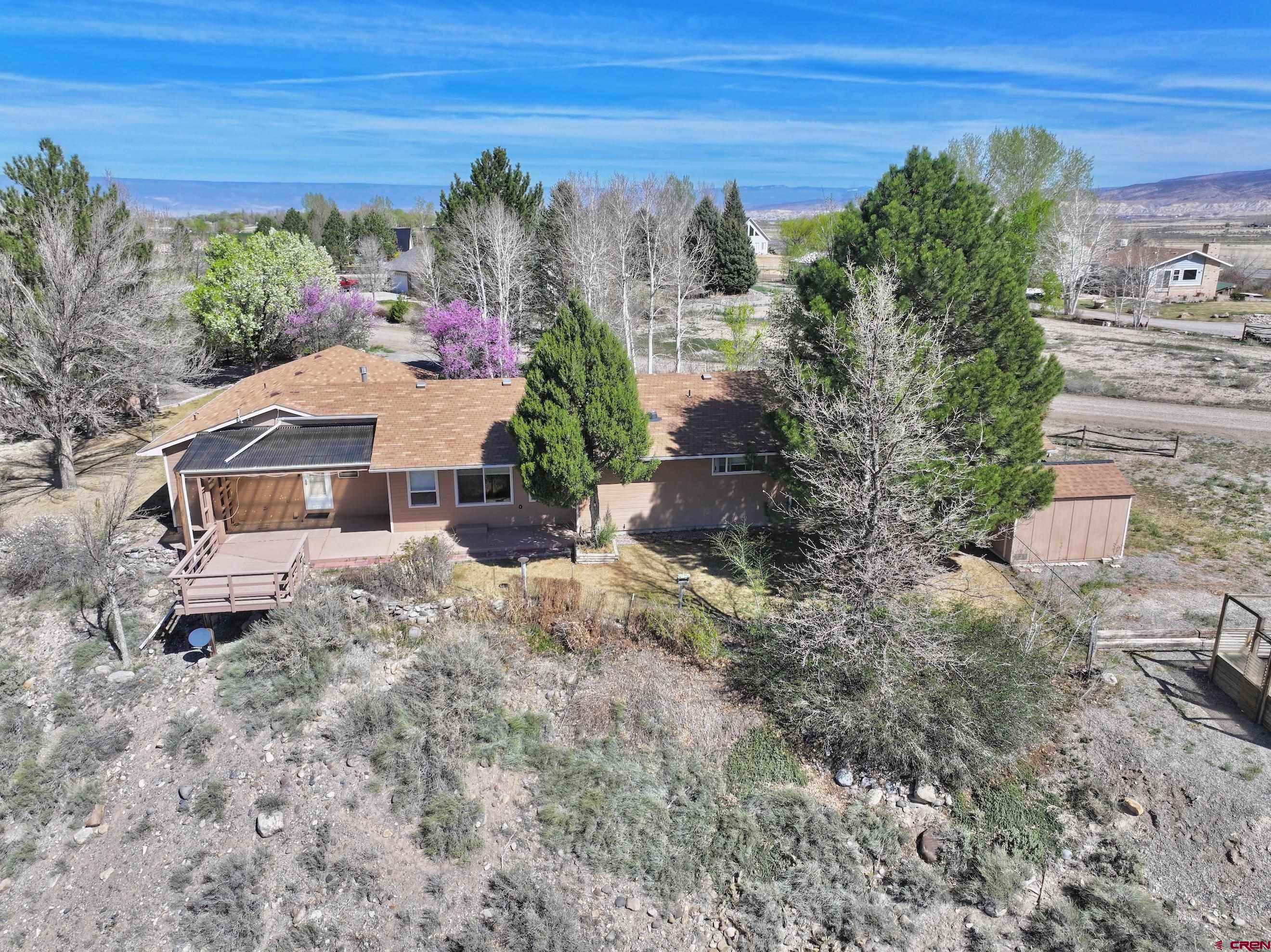 61460 Epitaph Road Montrose, CO 81403 - Photo 38 of 45 a aerial view of a house with a yard