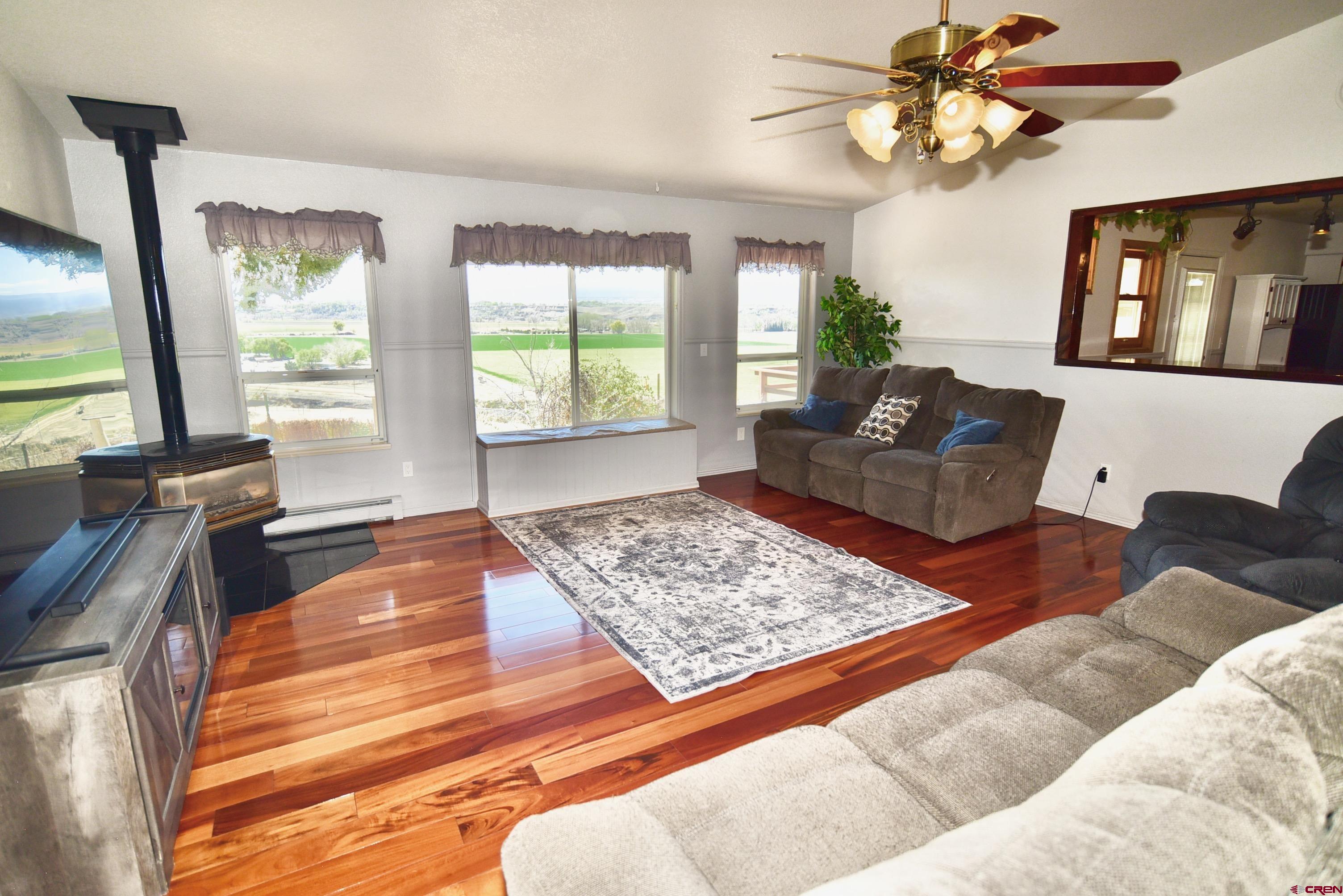 61460 Epitaph Road Montrose, CO 81403 - Photo 7 of 45 a living room with furniture and a flat screen tv