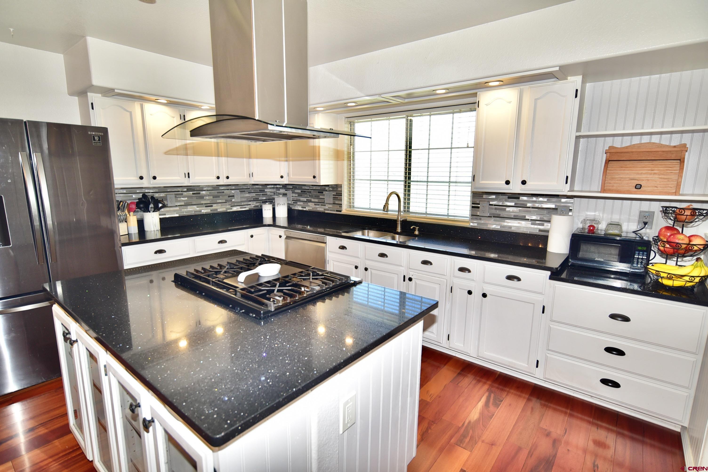 61460 Epitaph Road Montrose, CO 81403 - Photo 10 of 45 a kitchen with stainless steel appliances granite countertop a sink stove and refrigerator
