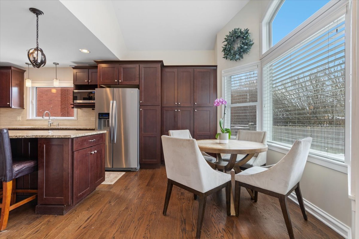 1104 South Lincoln Avenue Park Ridge, IL 60068 - Photo 12 of 37 a kitchen with stainless steel appliances a dining table chairs and wooden floor
