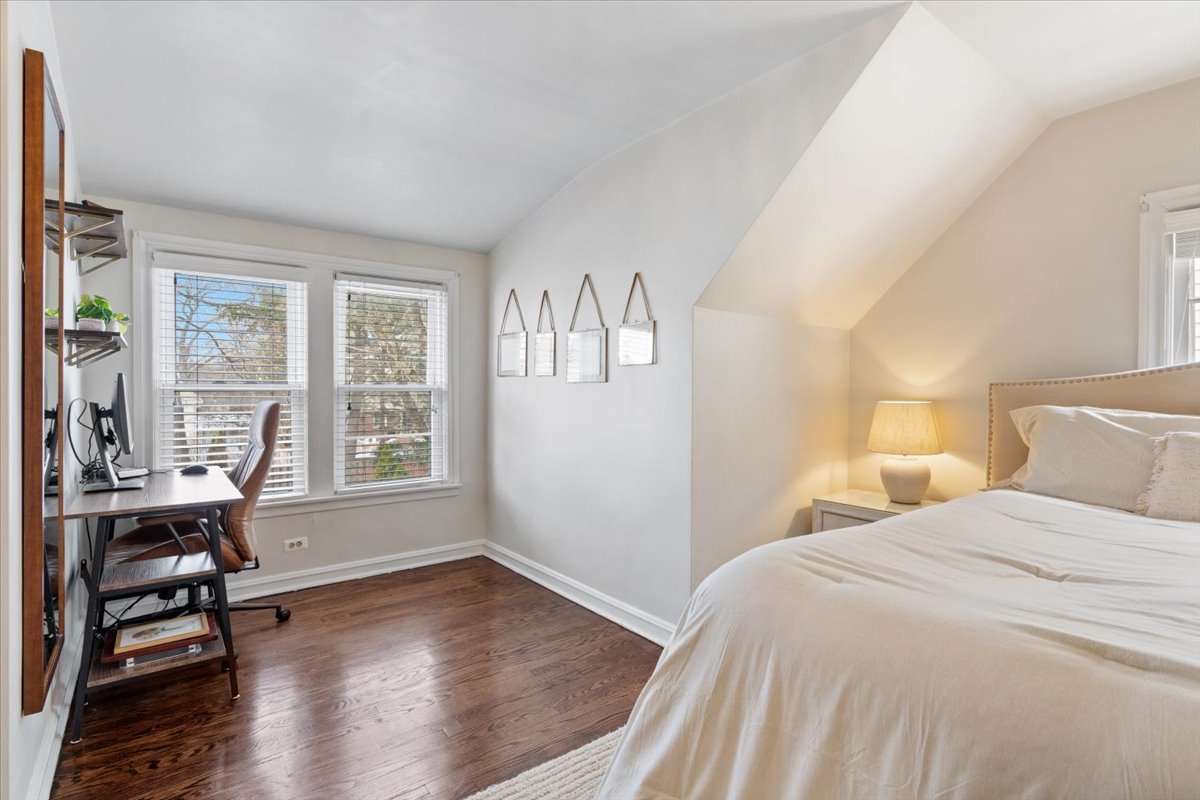 1104 South Lincoln Avenue Park Ridge, IL 60068 - Photo 19 of 37 a bedroom with a bed a table and a large window