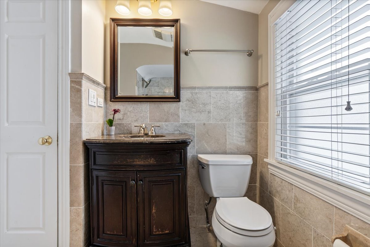 1104 South Lincoln Avenue Park Ridge, IL 60068 - Photo 22 of 37 a bathroom with a toilet a sink a vanity and mirror
