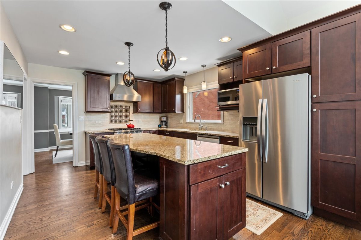 1104 South Lincoln Avenue Park Ridge, IL 60068 - Photo 10 of 37 a kitchen with stainless steel appliances granite countertop a refrigerator a sink dishwasher a stove and a refrigerator with wooden floor