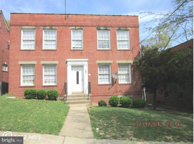 77 Forrester Street Southwest Washington, DC 20032 - Photo 1 of 22 front view of a brick house with a yard