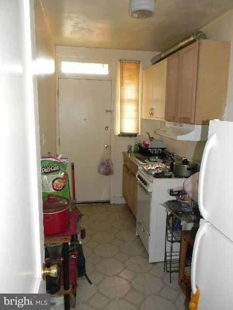 77 Forrester Street Southwest Washington, DC 20032 - Photo 5 of 22 a kitchen with a stove a sink and a refrigerator