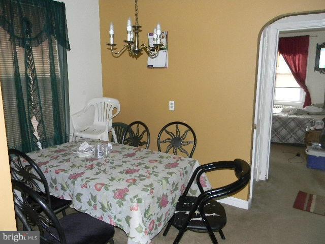 77 Forrester Street Southwest Washington, DC 20032 - Photo 6 of 22 a bedroom with a bed and a dresser next to a window