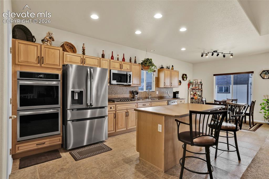 12266 Crystal Downs Road Peyton, CO 80831 - Photo 13 of 50 Double oven, gas cooktop, and pantry
