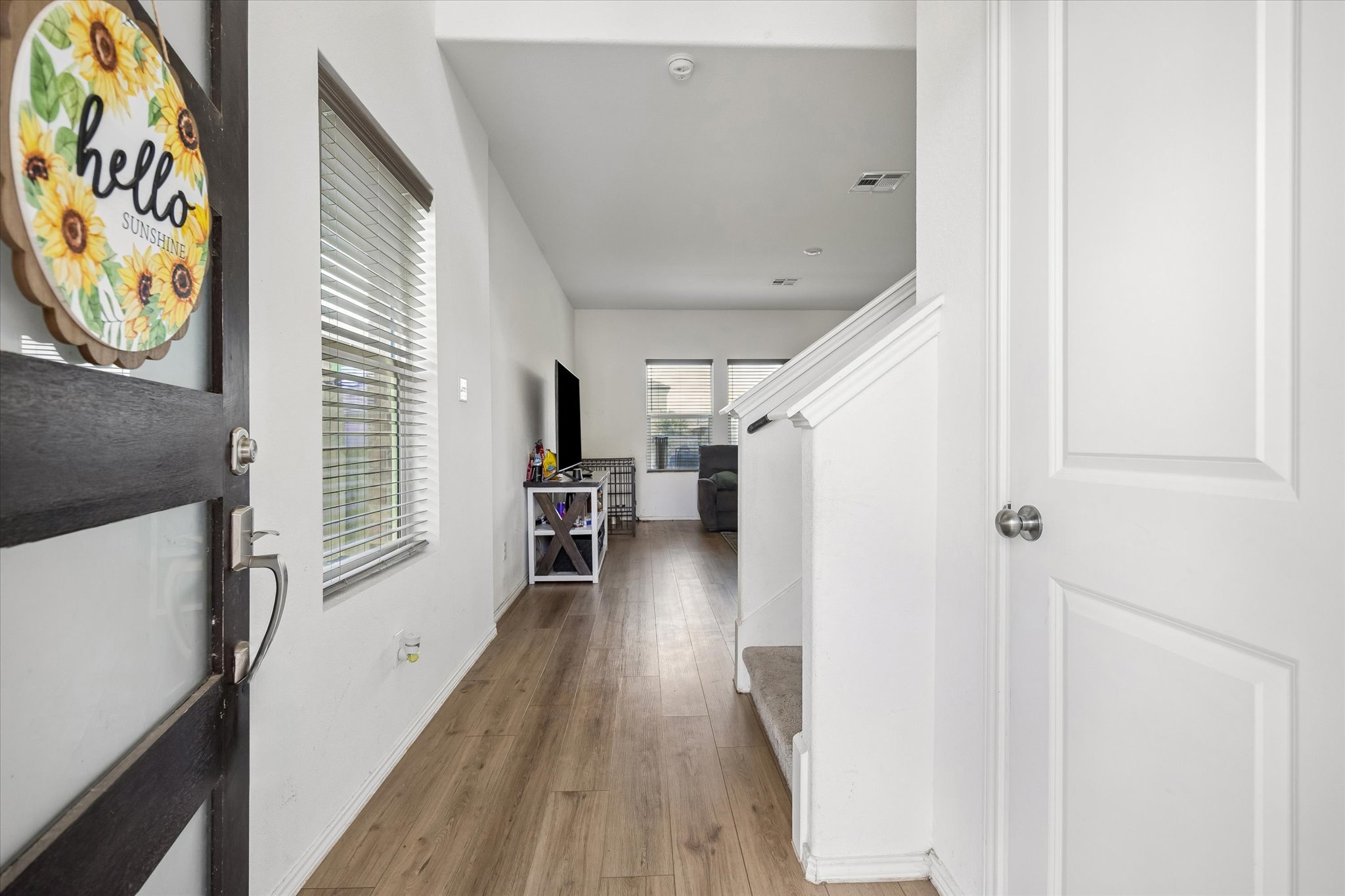 217 Canley Loop Hutto, TX 78634 - Photo 6 of 36 A welcoming entryway with a contemporary front door and warm wood flooring.