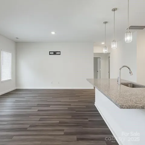 a view of a room with wooden floor and window