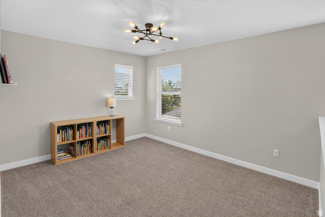 2178 Autumn Drive Mapleton, UT 84664 - Photo 37 of 48 Carpeted room with neutral wall tones, two windows with blinds, and a contemporary ceiling light fixture