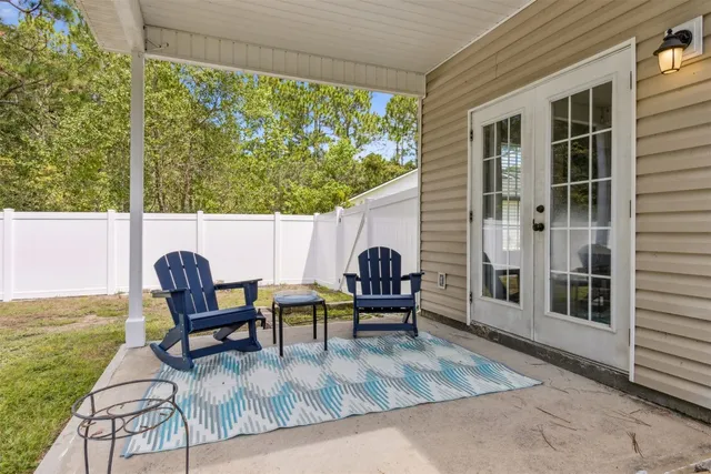 a view of a backyard with plants and a patio