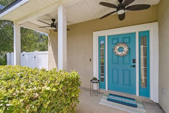 a view of a porch with wooden floor door and windows