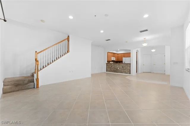 a kitchen with appliances a sink and cabinets