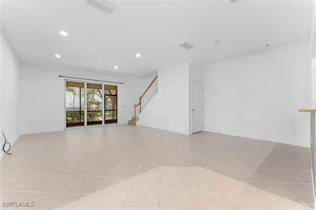 an empty room with a mirror and a shower