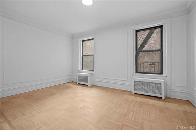 an empty room with windows and closet