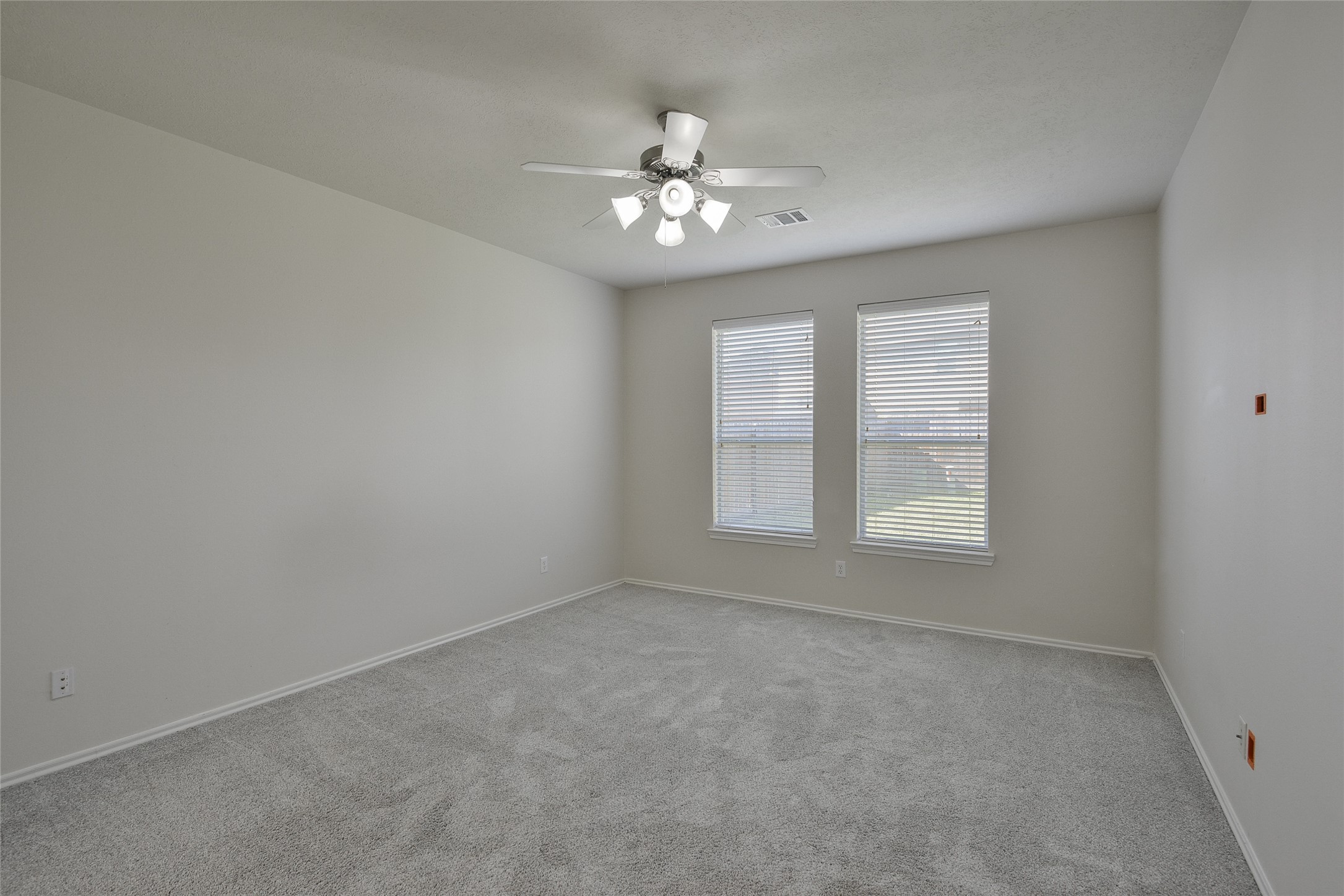 3618 Orchard Valley Lane Spring, TX 77386 - Photo 18 of 39 an empty room with chandelier fan and windows