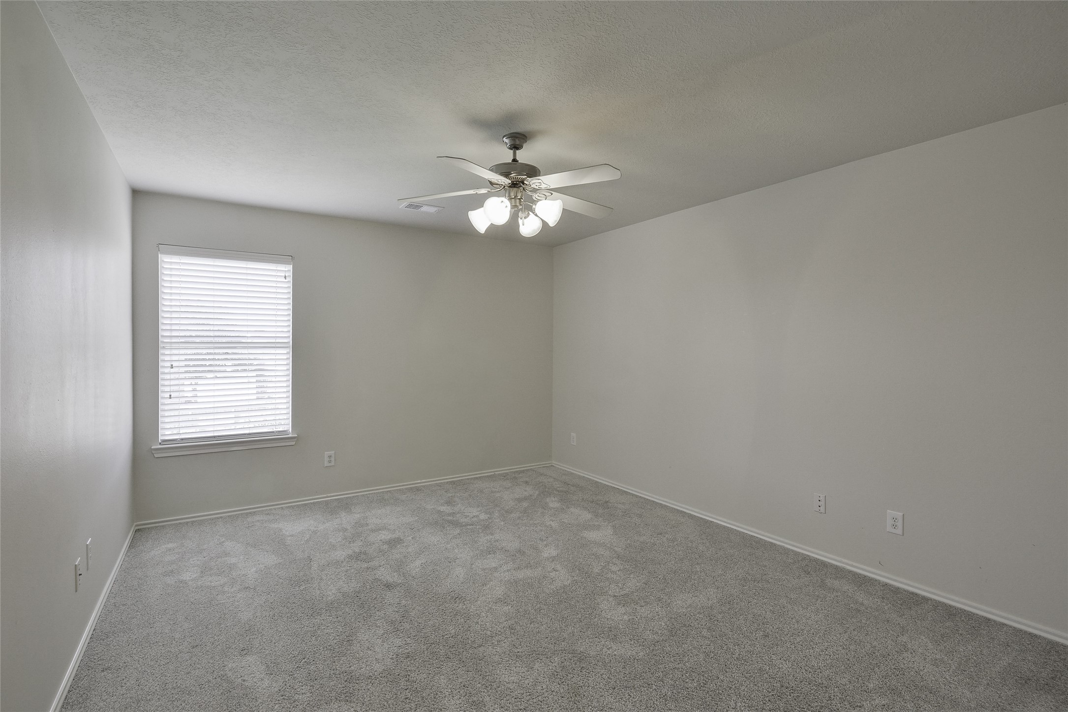 3618 Orchard Valley Lane Spring, TX 77386 - Photo 27 of 39 an empty room with a window and a ceiling fan