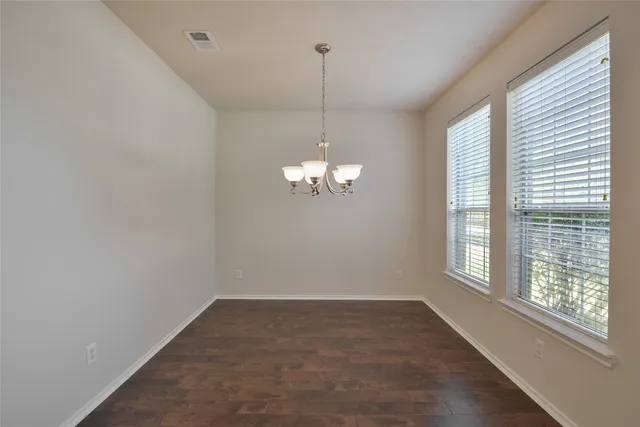 a view of a chandelier in big room and chandelier fan