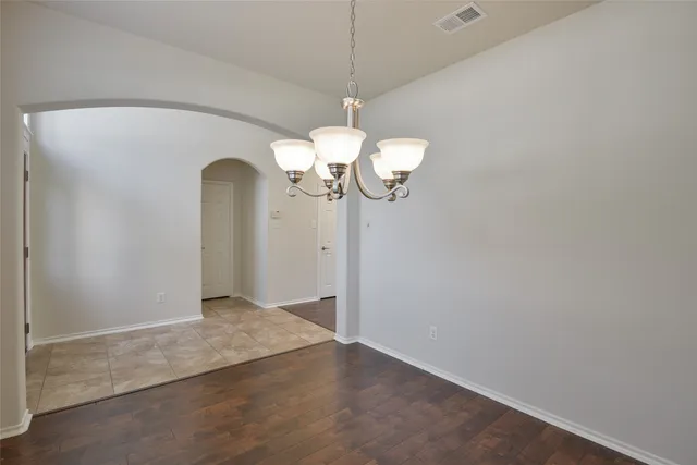 a view of a chandelier fan and wooden floor