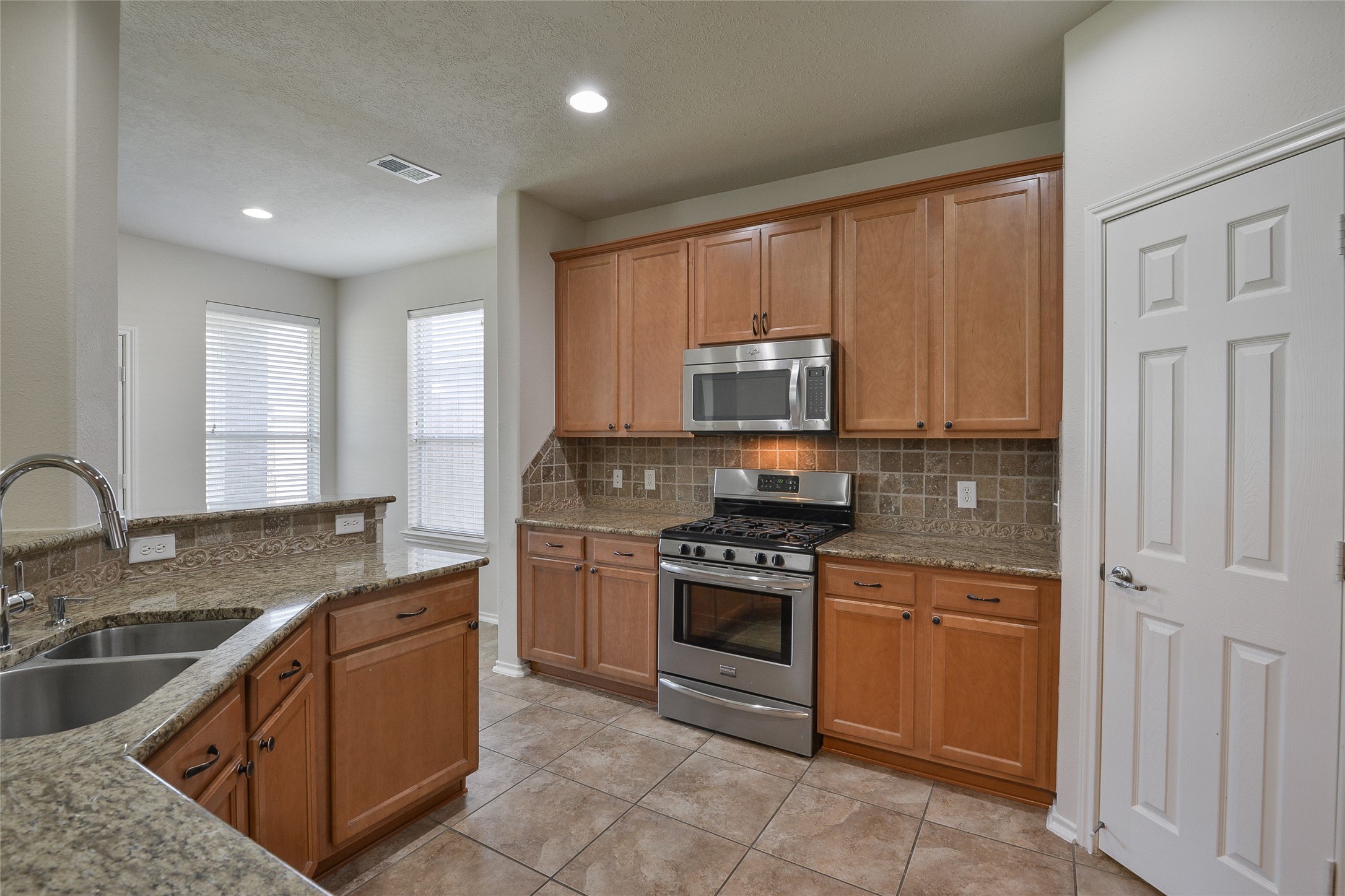 3618 Orchard Valley Lane Spring, TX 77386 - Photo 9 of 39 a kitchen with stainless steel appliances granite countertop a stove sink and cabinets