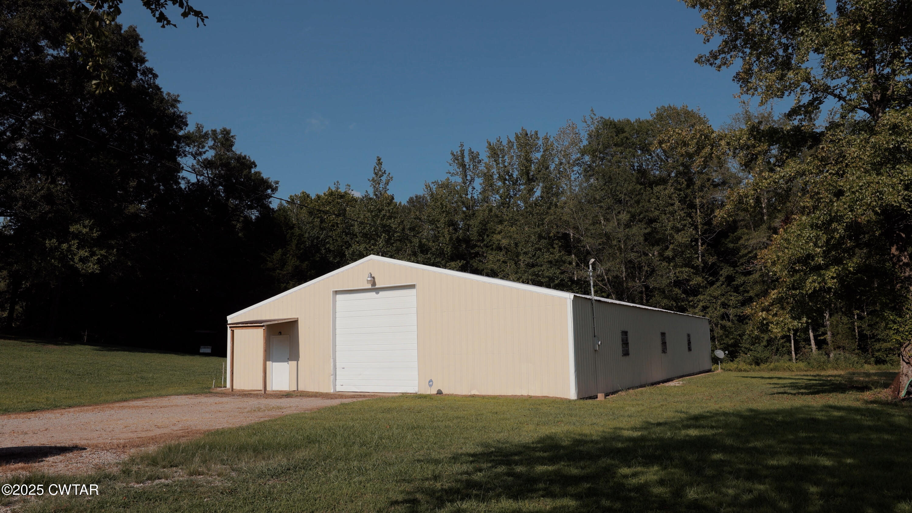 1110 Nuckolls Road Bolivar, TN 38008 - Photo 5 of 15 a backyard of a house with lots of green space and garden