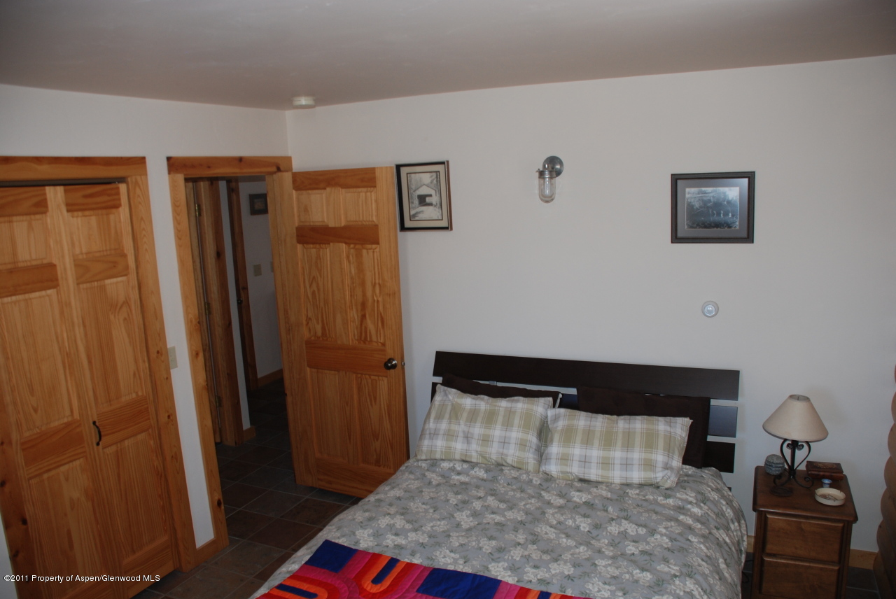 630 Foster Ridge Road Glenwood Springs, CO 81601 - Photo 18 of 27 a bedroom with a bed and a table