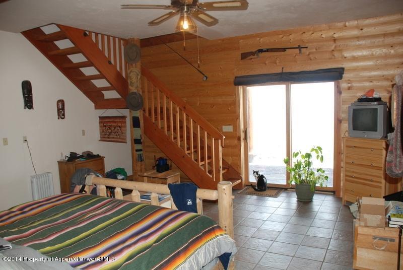 630 Foster Ridge Road Glenwood Springs, CO 81601 - Photo 22 of 27 a bedroom with furniture and a chandelier
