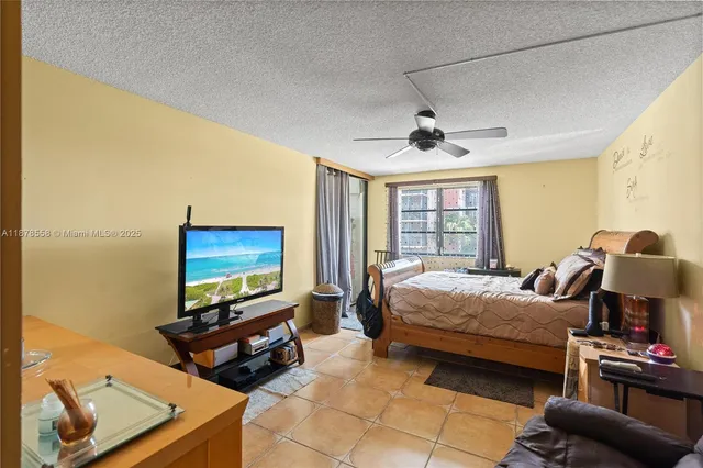 a bedroom with furniture and a flat screen tv