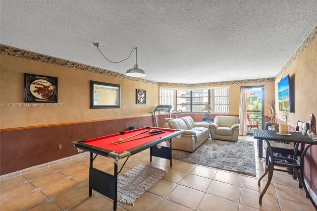 a living room with furniture a rug and a large window