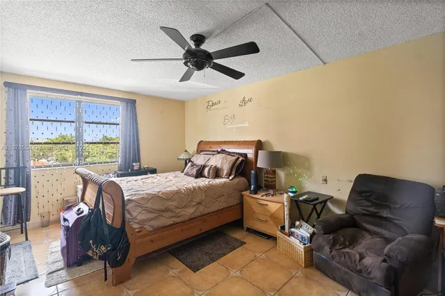 a bedroom with a bed couch and window