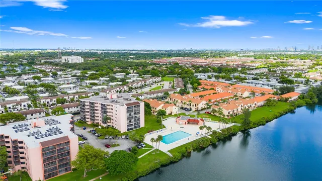an aerial view of residential houses with outdoor space and river