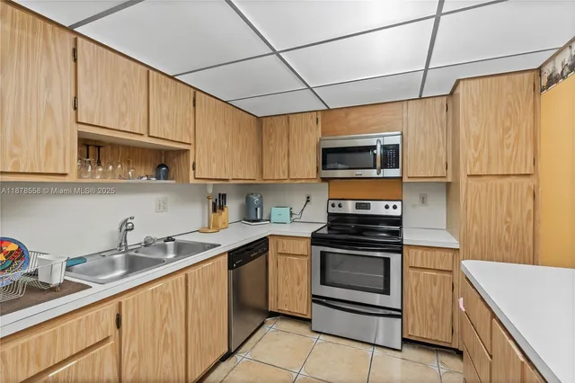 a kitchen with stainless steel appliances granite countertop a sink and a stove
